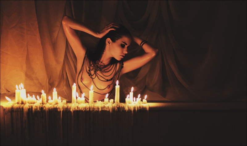 Рыжая девушка при свете свечи с голыми сисечками фото